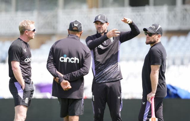 James Anderson (centre right) with England head coach Brendon McCullum 