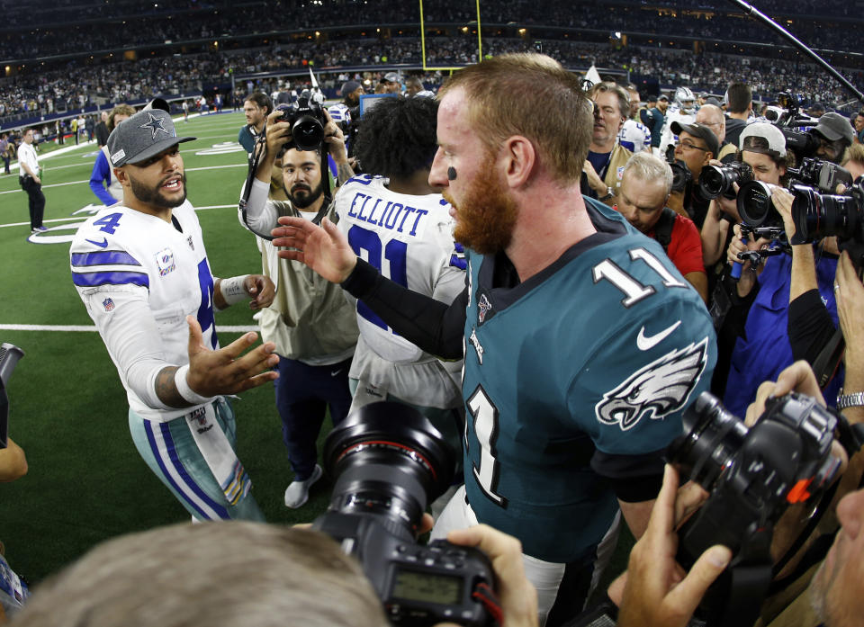 Dallas Cowboys quarterback Dak Prescott (4) and Philadelphia Eagles quarterback Carson Wentz (11) greet each other after their NFL football game in Arlington, Texas, Sunday, Oct. 20, 2019. (AP Photo/Ron Jenkins)