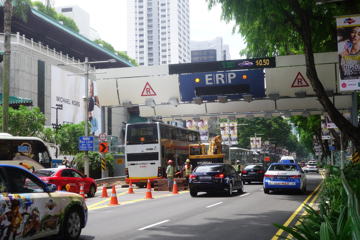 Cars passes through ERP gantry on a street in downtown Orchard in Singapore.