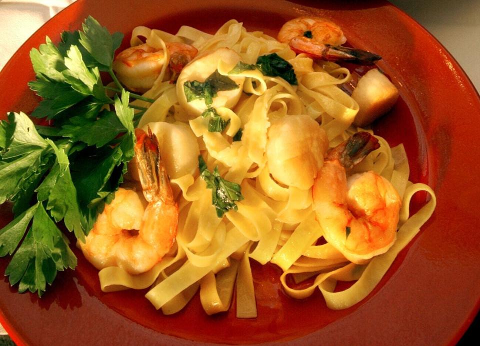 Tagliatelle al Pesce at Mamma Luisa Ristorante Italiano is made with egg ribbon pasta accompanied by sauteed shrimp and sea scallops with extra virgin olive oil, garlic and basil.