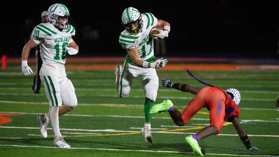 Mainland's Stephen Ordille, center, runs the ball in for a touchdown during the South Jersey Group 4 championship football game between Mainland and Millville played in Millville on Friday, November 10, 2023. Mainland defeated Millville, 35-13.