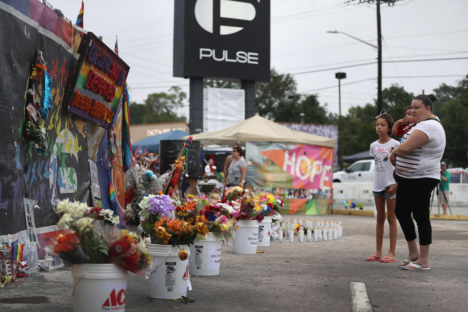 <p>People visit the memorial to the victims of the mass shooting setup around the Pulse gay nightclub one year after the shooting on June 12, 2017 in Orlando, Florida. (Joe Raedle/Getty Images) </p>