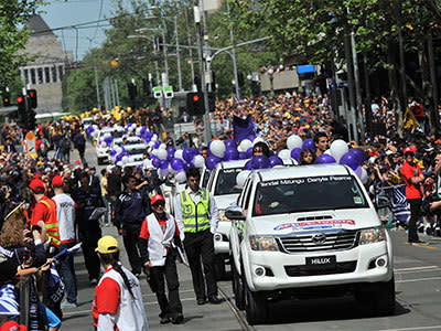 Players travel along Swanston Street during the Grand Final parade in Melbourne, Friday, Sept. 27, 2013. Photo: AAP