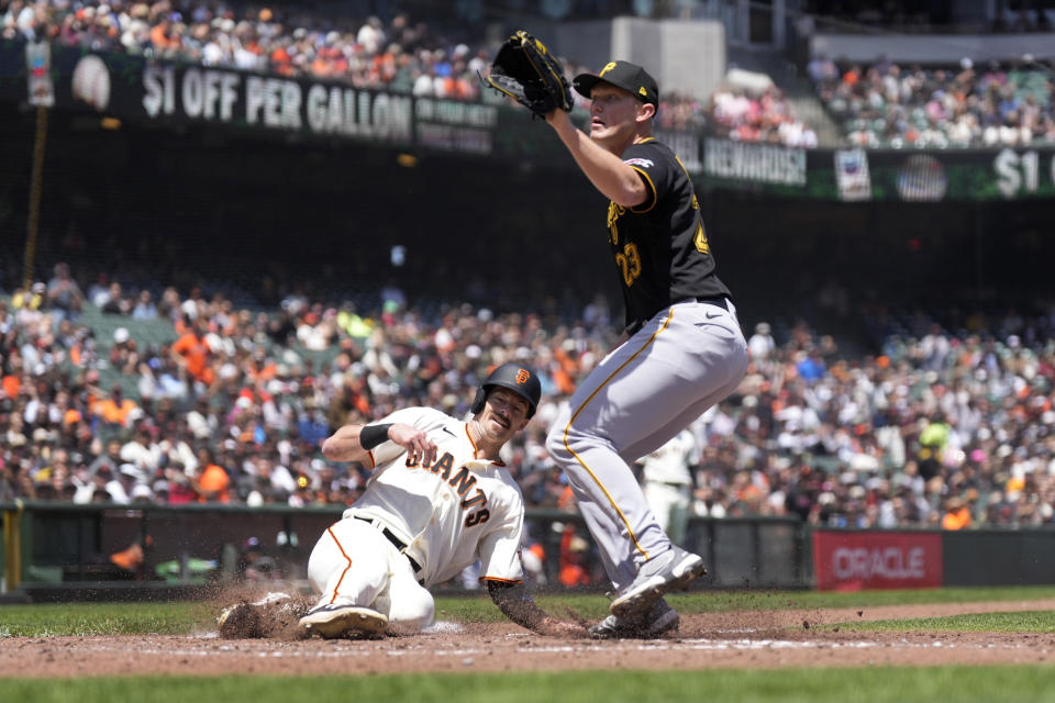 San Francisco Giants' Mike Yastrzemski scores a run on a wild pitch by Pittsburgh Pirates pitcher Mitch Keller, right, during the fifth inning of a baseball game in San Francisco, Wednesday, May 31, 2023. (AP Photo/Tony Avelar)