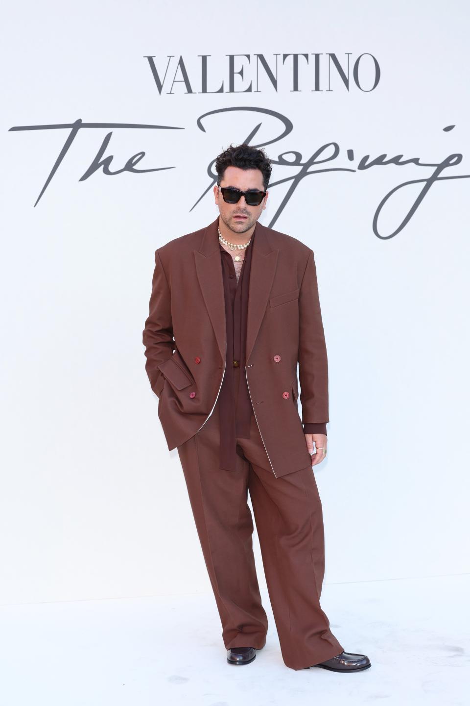 Dan Levy posing at Valentino's Haute Couture show in Rome, Italy.