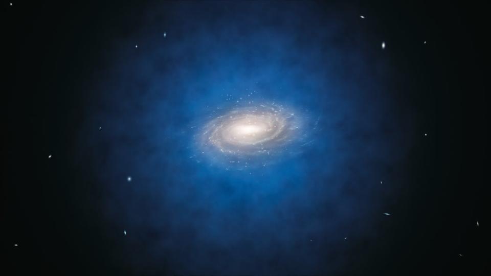 An illustration of a bright white galaxy surrounded by a blueish halo. The background of space takes up a large portion of the image.