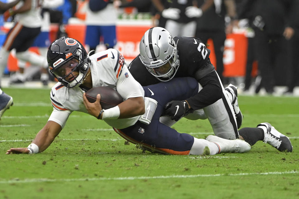 Las Vegas Raiders safety Johnathan Abram (24) tackles Chicago Bears quarterback Justin Fields (1) during the first half of an NFL football game, Sunday, Oct. 10, 2021, in Las Vegas. (AP Photo/David Becker)