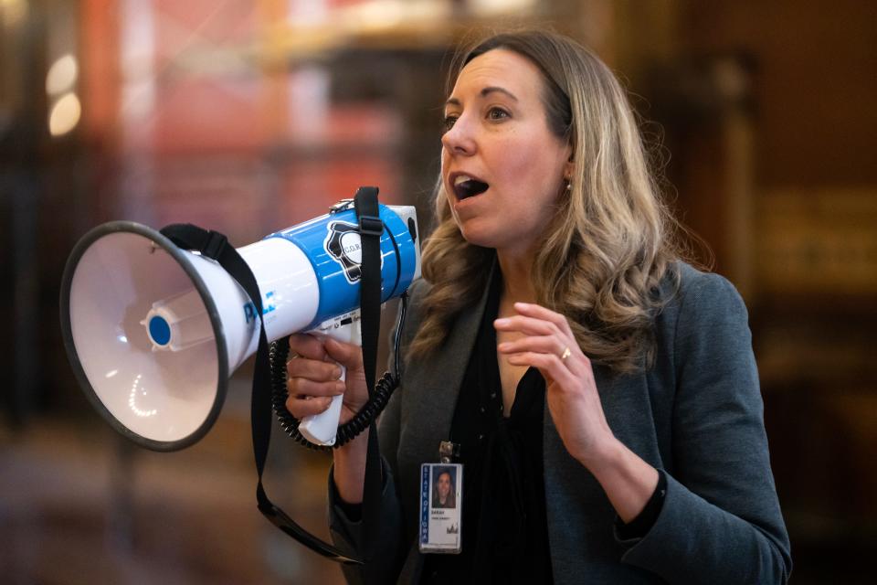 Sarah Trone Garriott, D-Windsor Heights, speaks to the crowd gathered for a protest against legislation that will allow Iowans to keep guns in locked cars in the parking lots of public buildings like schools, in the rotunda of the Iowa State Capitol, on Monday, April 24, 2023, in Des Moines. 