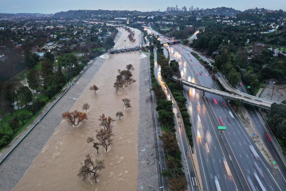 An aerial view of the Los Angeles River swollen by storm runoff as a powerful long-duration atmospheric river storm, the second in less than a week, continues to impact Southern California on February 5, 2024 in Los Angeles, California.