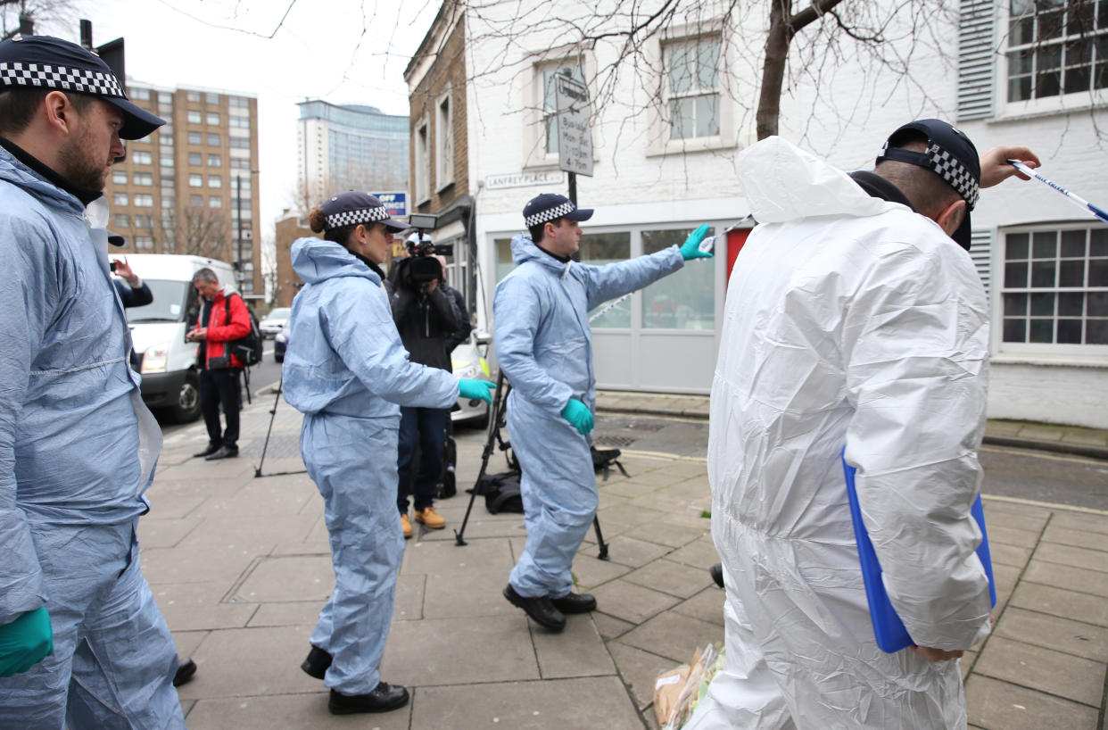 Police search for evidence following the stabbing (PA)