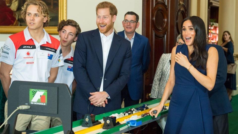 The Duchess of Sussex reacts after the big bang to start the students' mini-Formula 1 racing demonstration. (Photo: Entertainment Tonight)