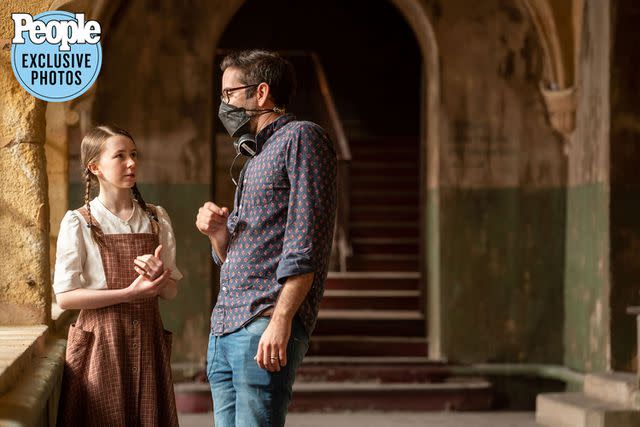 <p>Bruno Calvo</p> Director Michael Chaves working with actress Katelyn Rose Downey on "The Nun II" set.