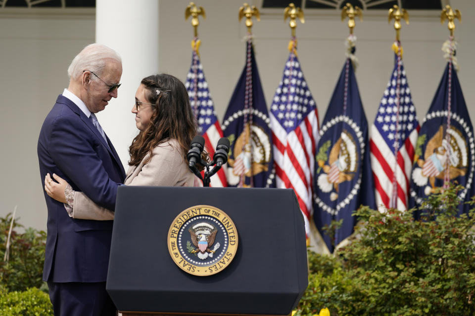 FILE - President Joe Biden hugs Mia Tretta, a survivor of the Saugus High School shooting in Santa Clarita, Calif., after she spoke in the Rose Garden of the White House in Washington, April 11, 2022. (AP Photo/Carolyn Kaster, File)