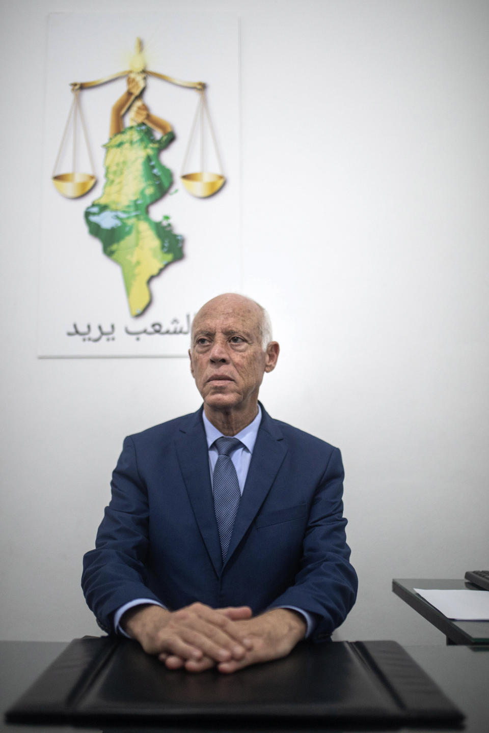 Tunisian former conservative constitutional law professor Kais Saied poses in his office in Tunis, Tunisia, Tuesday, Sept. 17, 2019. With more than half the votes in Tunisia's presidential race counted, Kais Saied was in the lead. Media magnate Nabil Karoui, a more modernizing candidate, was in second place with 15.5%. (AP Photo/Mosa'ab Elshamy)