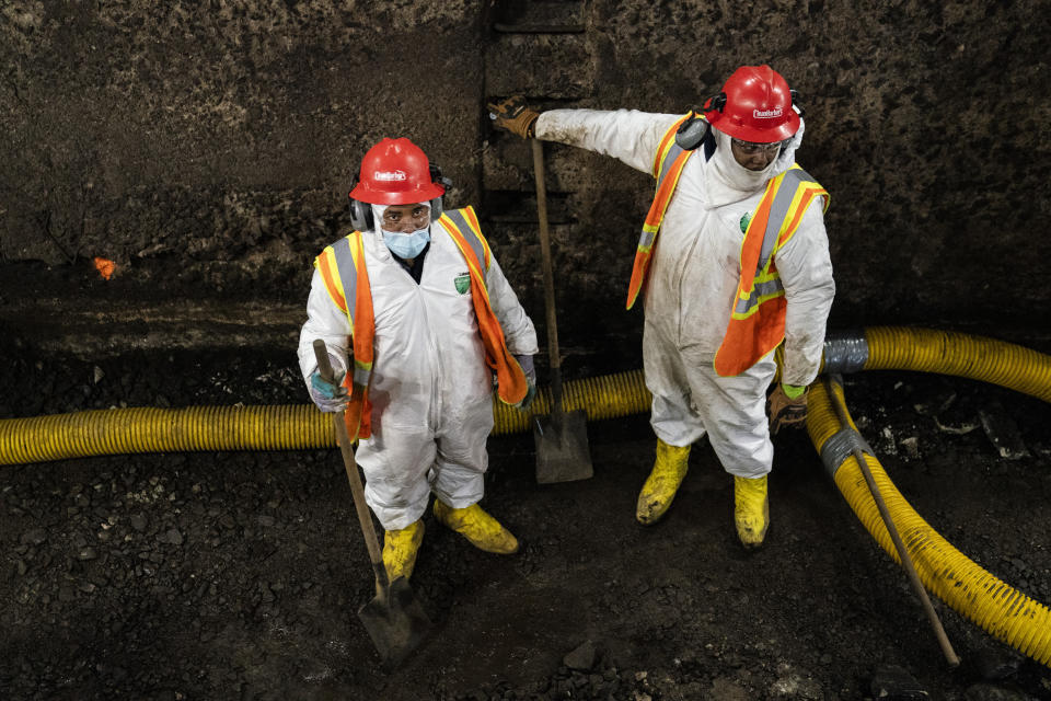 Amtrak workers perform tunnel repairs to a partially flooded train track bed, Saturday, March 20, 2021, in Weehawken, N.J. With a new rail tunnel into New York years away at best, Amtrak is embarking on an aggressive and expensive program to fix a 110-year-old tunnel in the interim. (AP Photo/John Minchillo)