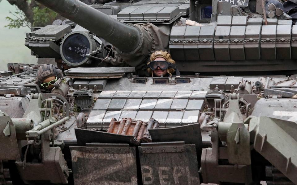 A service member of pro-Russian troops drives a tank during Ukraine-Russia - ALEXANDER ERMOCHENKO/ REUTERS