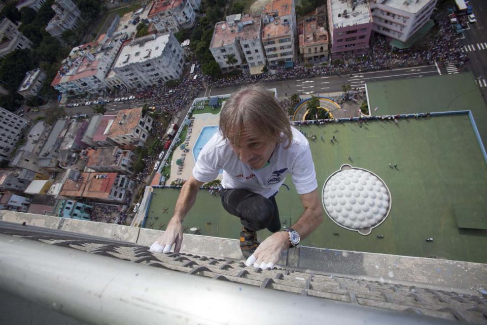 French daredevil Alain Robert scales the Habana Libre hotel without using ropes or a safety net, in Havana, Cuba, Monday, Feb. 4, 2013. Once the city's Hilton, Robert was able to reach the top of the 27-story building in 30 minutes. Robert has scaled much taller buildings in his career. He says his main concern is that the hotel is in disrepair like other Havana landmarks. (AP Photo/Ramon Espinosa, Pool)