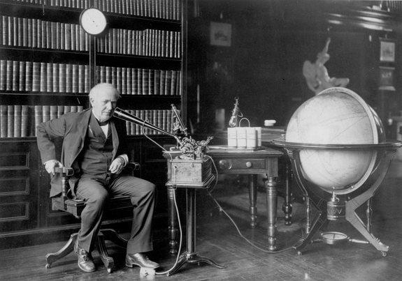 Thomas Edison dictating to an Ediphone in his library.