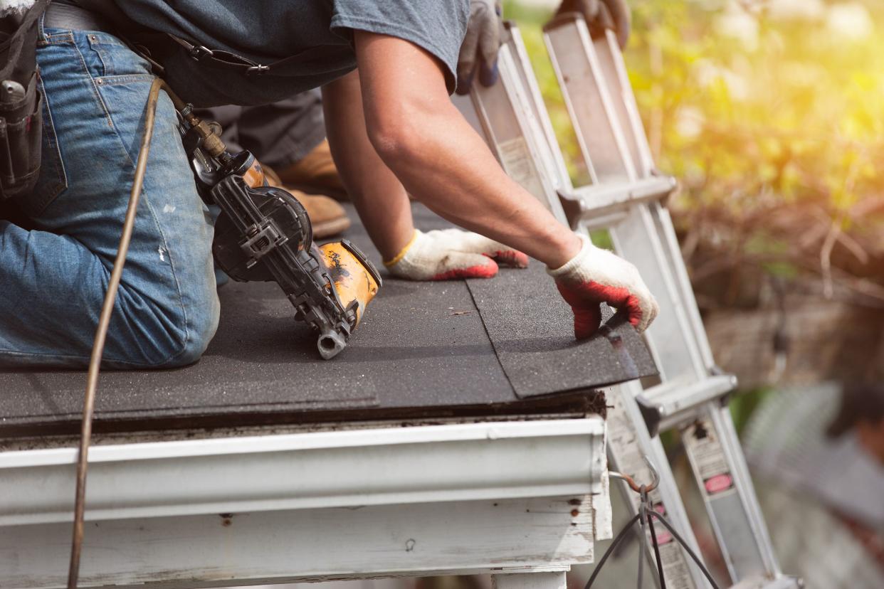 roofers installing a new roof on residential home