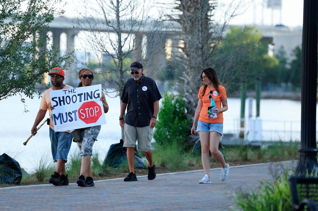 Jacksonville residents march along the Northbank Riverwalk for Gun Violence Awareness Day & Wear Orange Weekend in June. Jacksonville is on pace to have fewer than 100 homicides for only the third time in the 21 years since the Times-Union has chronicled the city's death toll.