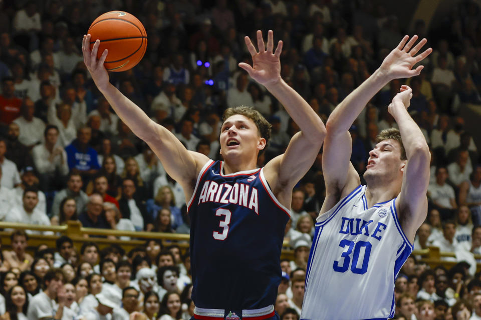 Arizona guard Pelle Larsson (3) drives to the basket against Duke center Kyle Filipowski, right, during the first half of an NCAA college basketball game in Durham, N.C., Friday, Nov. 10, 2023. (AP Photo/Nell Redmond)