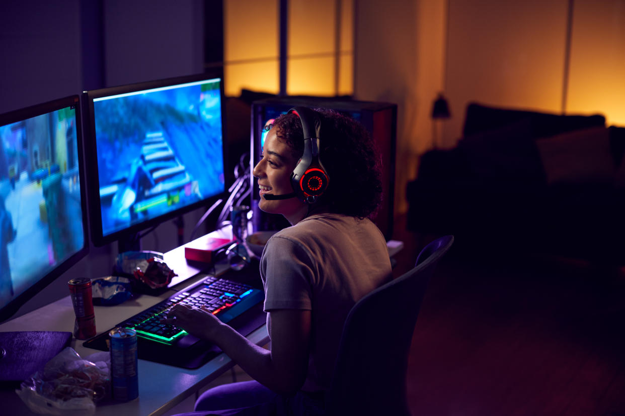 Teenage Girl Wearing Headset Gaming At Home Using Dual Computer Screens - Credit: Monkey Business/Adobe Stock