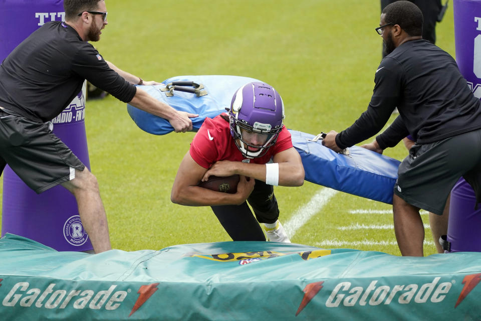 Minnesota Vikings rookie quarterback Kellen Mond goes through a drill during NFL football practice in Eagan, Minn., Wednesday, June 2, 2021.(AP Photo/Jim Mone)