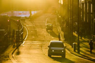 Moderate traffic as the sun sets on Piccadilly, in London, Tuesday, Nov. 24, 2020. Haircuts, shopping trips and visits to the pub will be back on the agenda for millions of people when a four-week lockdown in England comes to an end next week, British Prime Minister Boris Johnson said Monday. (AP Photo/Alberto Pezzali)