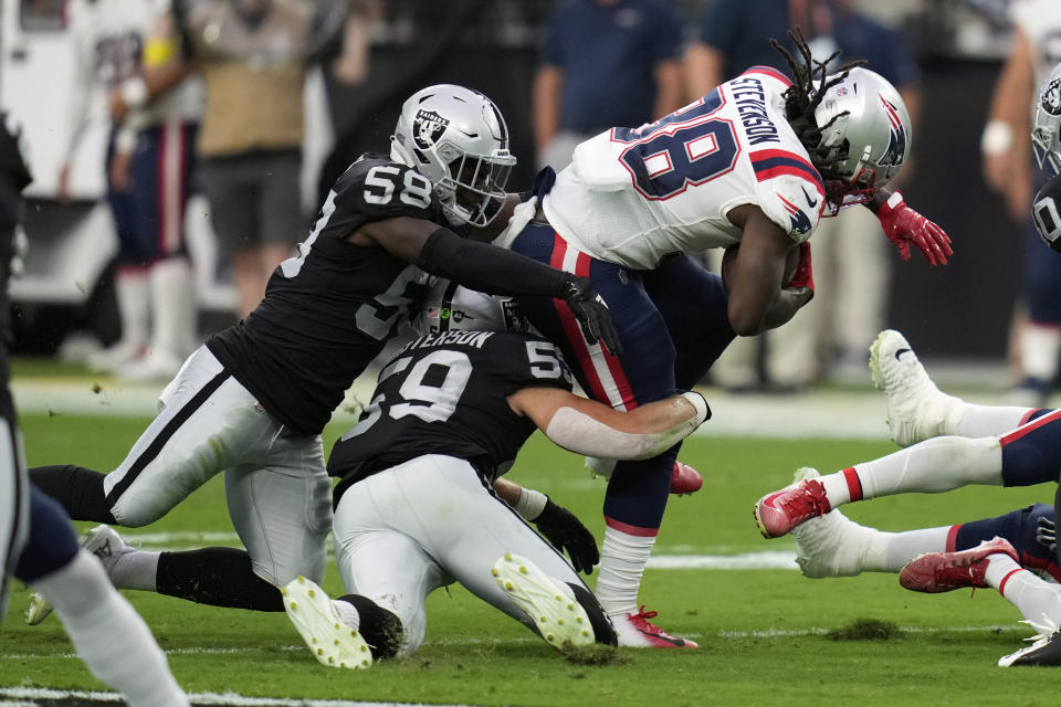 Las Vegas Raiders linebackers Darien Butler (58) and Luke Masterson (59) tackle New England Patriots running back Rhamondre Stevenson (38) during the first half of an NFL preseason football game, Friday, Aug. 26, 2022, in Las Vegas. (AP Photo/John Locher)