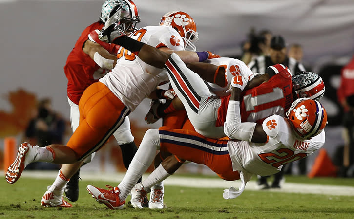 Ohio State Buckeyes wide receiver Corey Brown is tackled by Clemson Tigers linebacker Spencer Shuey and newest Vikings' safety Jayron Kearse.