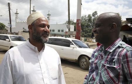 Clive Wanguthi (R), a Muslim leader, talks to a man near a mosque in Muslim-dominated Eastleigh neighbourhood in Kenya's capital Nairobi December 9, 2014. REUTERS/Katy Migiro