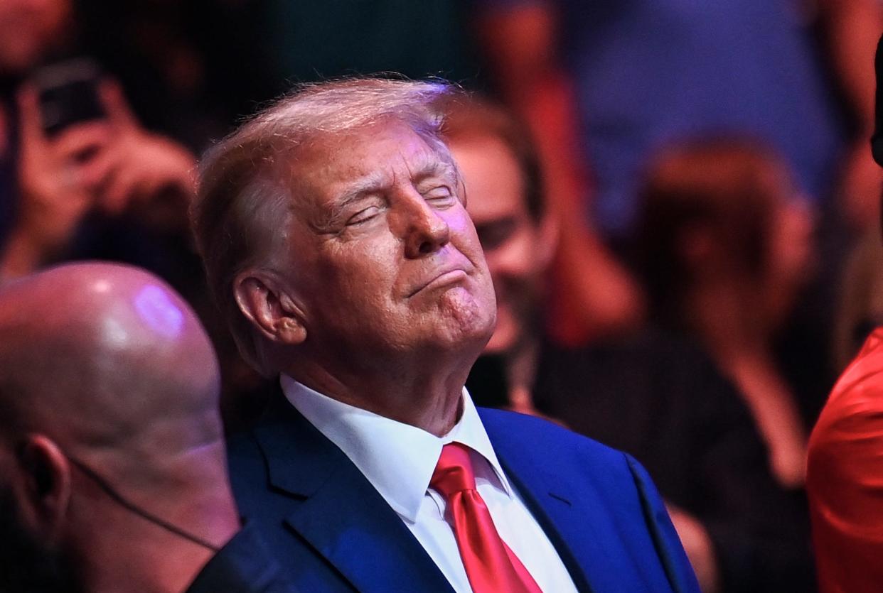 Former US President Donald Trump smiles while attending the Ultimate Fighting Championship 287 mixed martial arts event at the Kaseya Center in Miami, Florida, on April 8, 2023.