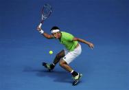 Leonardo Mayer of Argentina hits a return to Novak Djokovic of Serbia during their men's singles match at the Australian Open 2014 tennis tournament in Melbourne January 15, 2014. REUTERS/Jason Reed