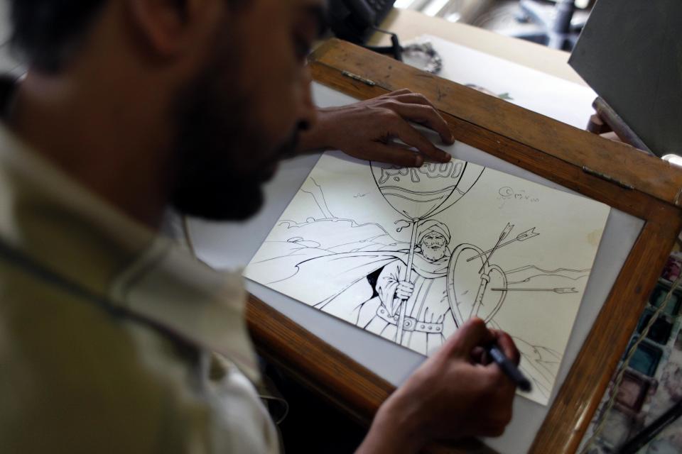 Egyptian cartoonist Khalid Abdul-Ati from the Egyptian Al Watan daily newspaper works on a cartoon depicting an Islamic figure inside his office at the newspaper's headquarters in Cairo, Egypt, Wednesday, Sept. 26, 2012. Amid outrage sparked by perceived insults to Islam, one Egyptian newspaper has decided to fight cartoons with cartoons. Al Watan daily says it is responding to the crude caricatures published last week by a satirical Parisian weekly in kind: a series of sketches critiquing relations between the Arab world and the West. The paper says they are a “civilized” alternative to the violent protests across the Muslim world sparked by a low-budget anti-Islam film produced in the United States. (AP Photo/Nasser Nasser)