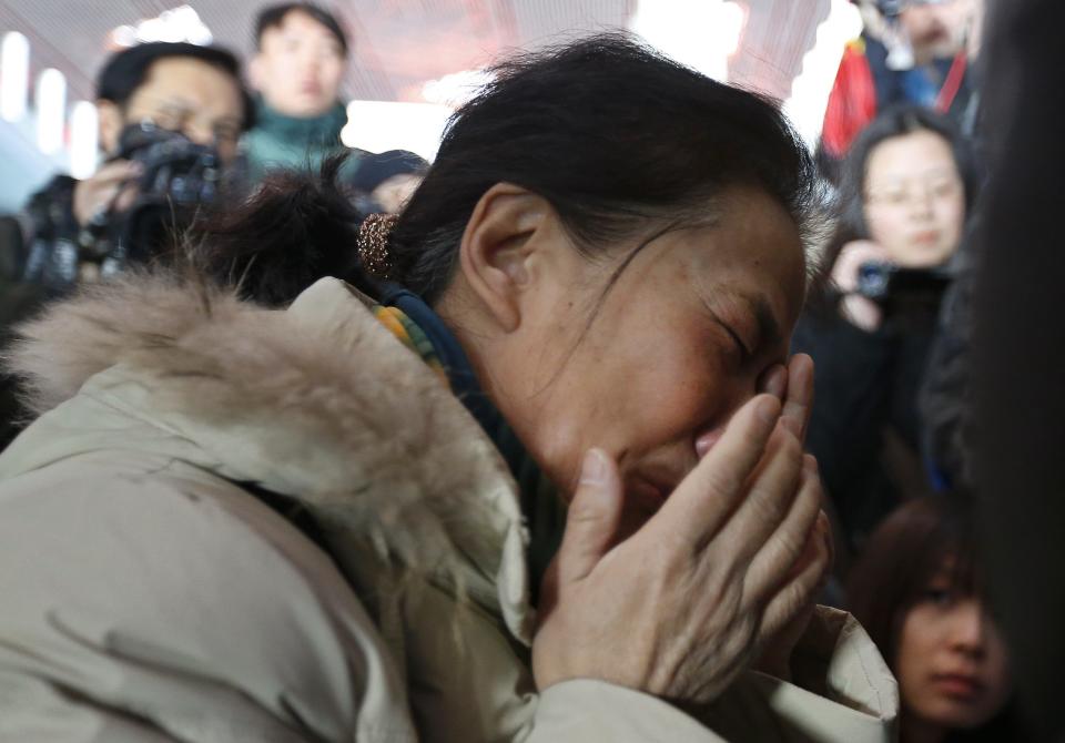 A relative of a passenger onboard Malaysia Airlines flight MH370 cries at the Beijing Capital International Airport