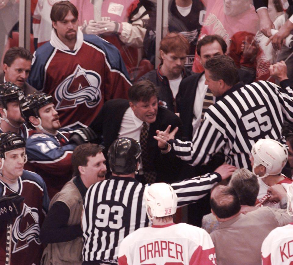 Avalanche coach Marc Crawford tried to crawl over the glass to get to the Red Wings bench and coach Scotty Bowman late in the third period at Joe Louis Arena in Game 4, May 22, 1997.