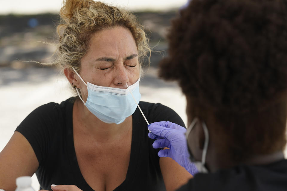 FILE - In this Thursday, July 15, 2021 file photo, Paola Preciado gets a COVID-19 test in North Miami, Fla. The U.S. surgeon general said Sunday, July 18 that he's concerned about what lies ahead with cases of COVID-19 increasing in every state, millions still unvaccinated and a highly contagious virus variant spreading rapidly. (AP Photo/Marta Lavandier, File)