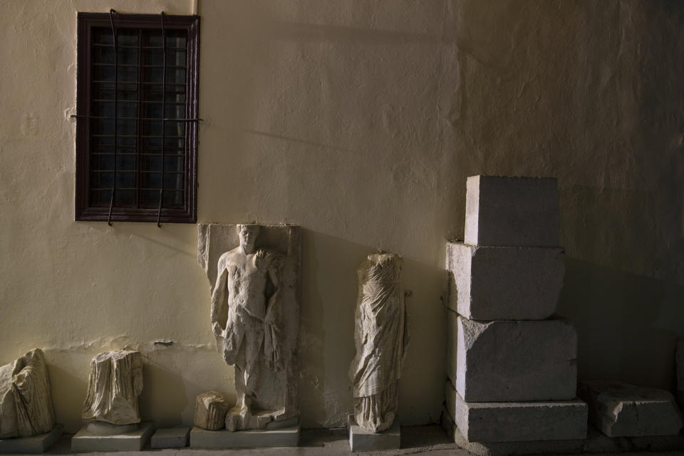 Ancient marble statues are seen outside the Archaeological Museum of Epidaurus next the ancient theatre of the site, early Saturday, July 186, 2020. Greek Culture Ministry allowed the ancient theaters of Epidaurus in southern Greece and Herodes Atticus in Athens to host performances under strict safety guidelines due the COVID-19 pandemic.(AP Photo/Petros Giannakouris)