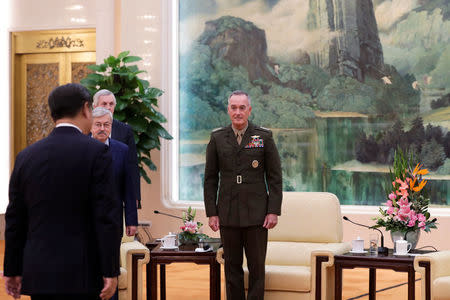 U.S. Chairman of the Joint Chiefs of Staff Gen. Joseph Dunford and U.S. Ambassador to China Terry Branstad watch Chinese President Xi Jinping walk their way for a meeting at the Great Hall of the People in Beijing, China August 17, 2017. REUTERS/Andy Wong/Pool