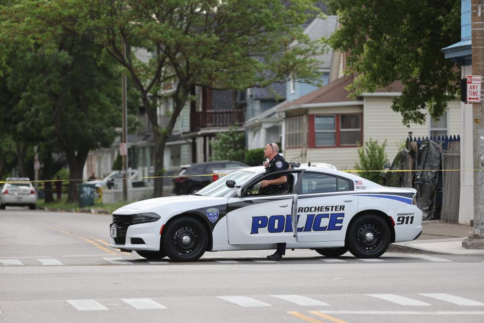 A Rochester police officer blocks at intersection at Avenue D and Hudson Avenue after Timothy Flowers was shot and killed by RPD June 4, 2021.