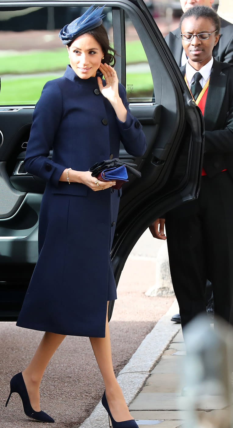 Meghan Markle accessorised with a navy hat and clutch bag. [Photo: Getty]