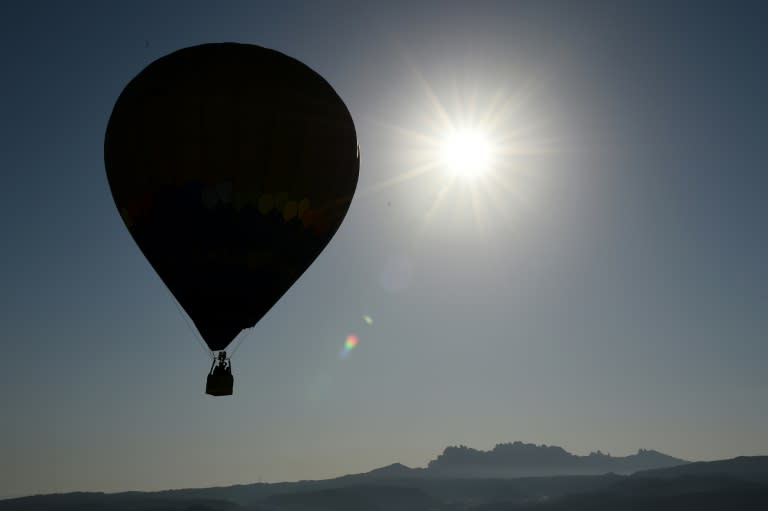 A hot-air balloon flies close to Montserrat mountain during the 20th European Balloon Festival in Igualada, near Barcelona, on July 7, 2016