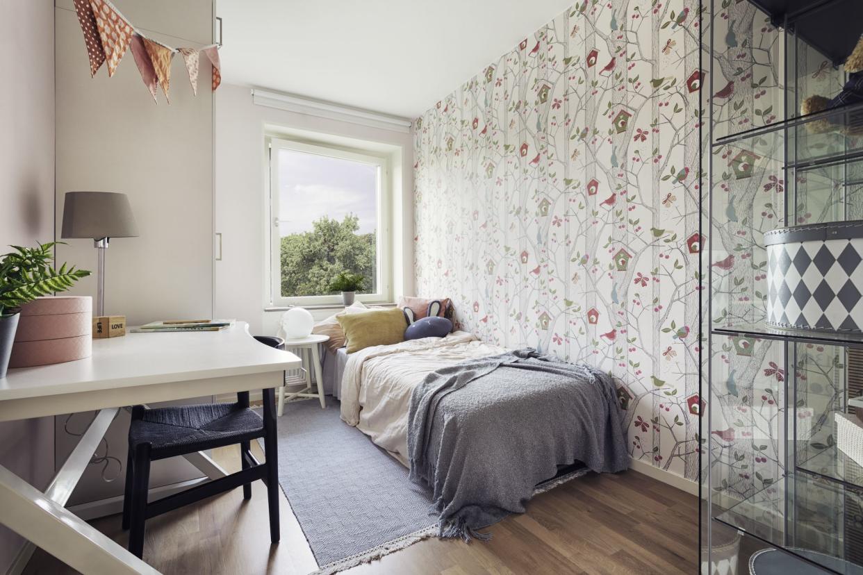 A child’s bedroom with bright wallpaper