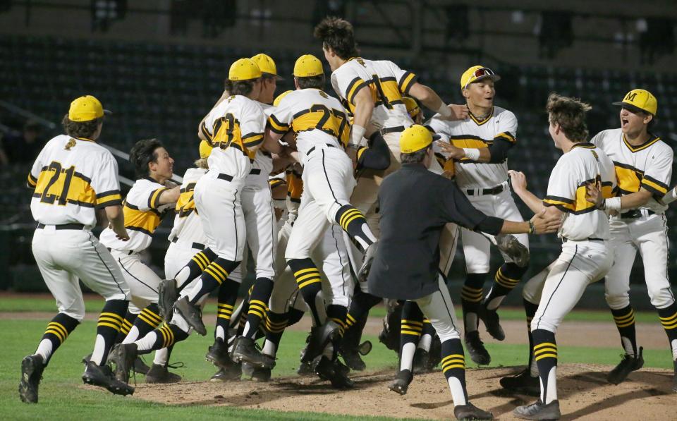 McQuaid players celebrate around the pitchers mound after the last out giving them the Section V Class AA championship final win over Victor at Frontier Field Tuesday, May 31, 2022 in Rochester.  McQuaid won the game and championship 2-1. 