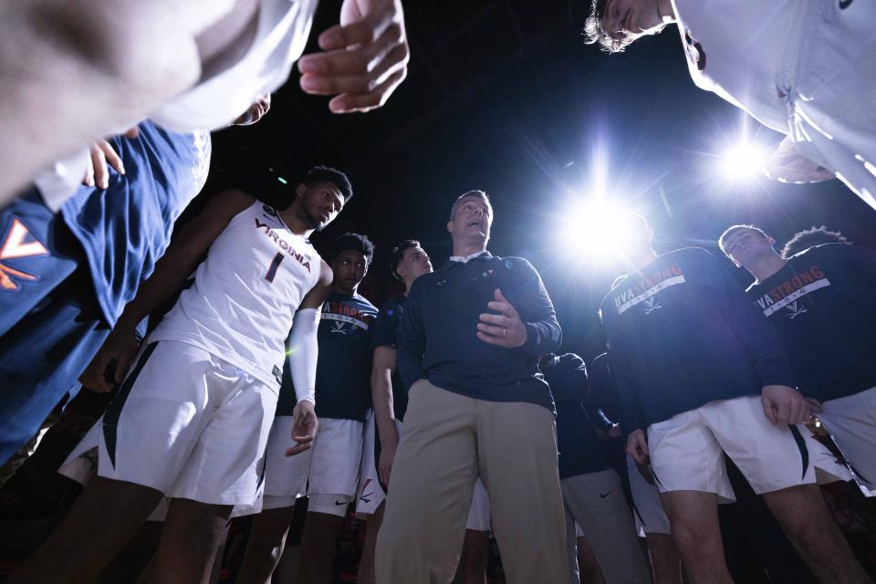 Virginia head coach Tony Bennett talks to his team before an NCAA college basketball game against Louisville in Charlottesville, Va., Saturday, March 4, 2023. (AP Photo/Mike Kropf)