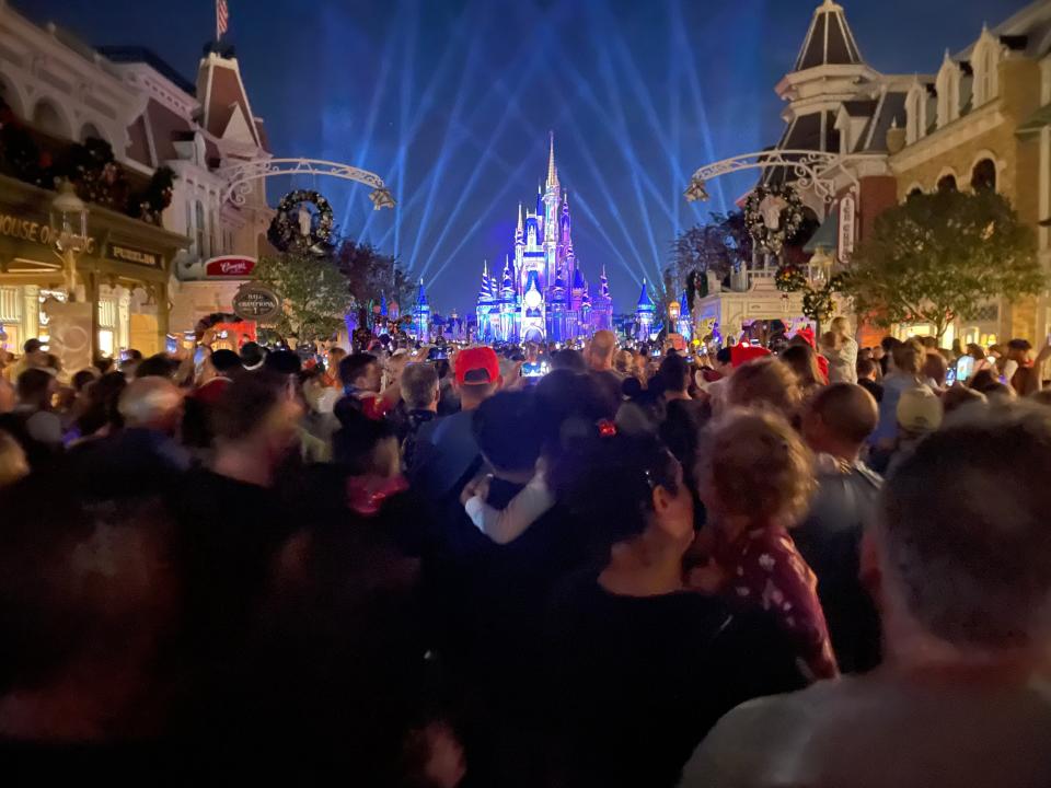 crowds gathered to watch the fireworks show at magic kingdom