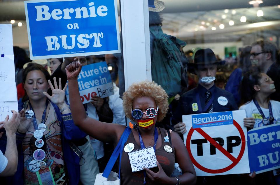 Supporters and delegates of Senator Bernie Sanders protest from inside and outside the glass of the convention arena after they stormed off the convention floor when Hillary Clinton won the Democratic presidential nomination during the second day at the Democratic National Convention in Philadelphia, Pa., on July 26, 2016. (Photo: Mark Kauzlarich/Reuters)