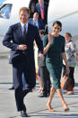 <p>For the Duke and Duchess of Sussex’s first overseas engagement as newlyweds to Dublin, Meghan dressed diplomatically in a £1,105 forest green skirt by Givenchy. She accessorised the look with a £475 Strathberry midi tote.<em> [Photo: PA]</em> </p>