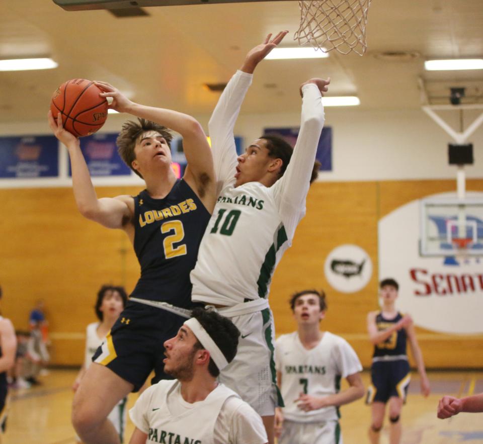 Lourdes' Mike Sabini and Spackenkill's Kristofer Cummings collide mid air during the MHAL boys basketball final on February 23, 2023. 