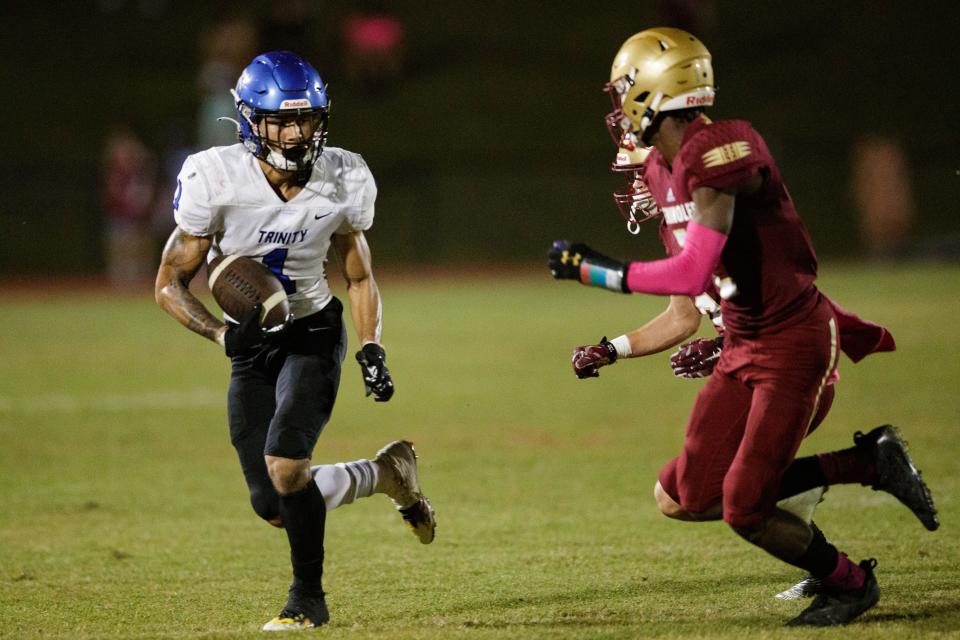 Trinity Christian's Cam Miller(1) sprints towards the end zone. The Florida High Seminoles defeated the Trinity Christian Conquerers 31-17 Friday, Oct. 15, 2021.